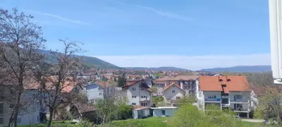 a group of houses on a hill with a town at Apartman Ivana in Soko Banja