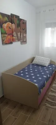 a bed in a room with a teddy bear on it at Apartman Ivana in Soko Banja