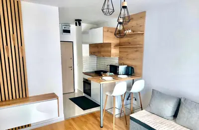 a small kitchen with a table and chairs in a room at Apartman Lena in Vrnjačka Banja