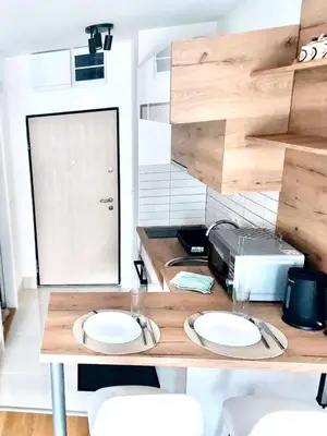 a kitchen with a counter with two white plates on it at Apartman Lena in Vrnjačka Banja