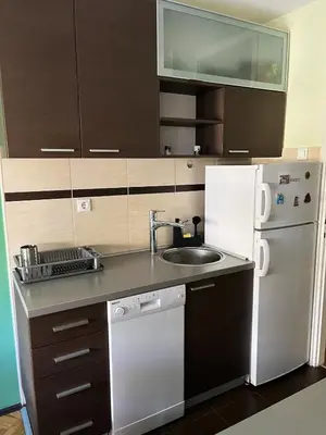 a small kitchen with a sink and a refrigerator at Cozy place for a perfect trip next to Delta Planet in Niš