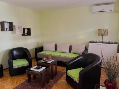 a living room with two chairs and a couch at Cozy place for a perfect trip next to Delta Planet in Niš