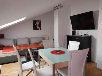 a living room with a table and a couch at Apartman u Nisu in Niš