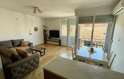 a living room with a couch and a table at La Familia Apartmani in Vrnjačka Banja