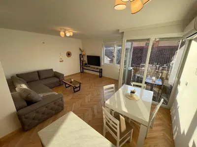 a living room with a couch and a table at La Familia Apartmani in Vrnjačka Banja