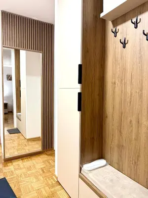 a bathroom with a mirror and a dressing room at Maribelle Apartments in Kruševac
