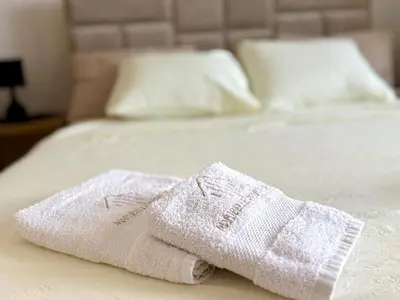 two towels sitting on top of a bed at Maribelle Apartments in Kruševac