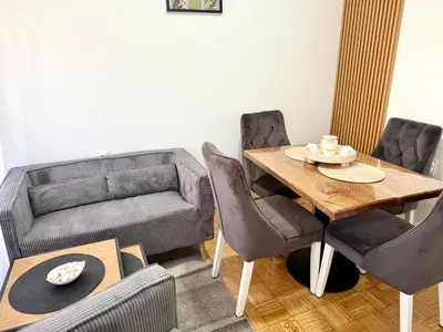 a living room with a table and a couch at Maribelle Apartments in Kruševac