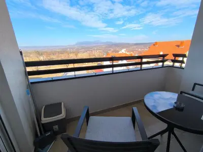 a balcony with a table and chairs and a view at COMODO 