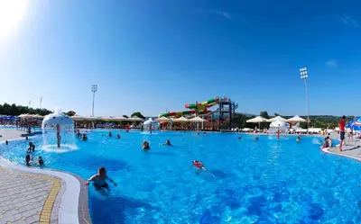 a group of people in a large swimming pool at COMODO 