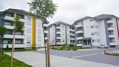 a row of apartment buildings in a parking lot at COMODO 