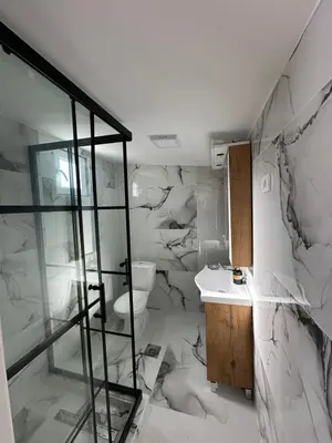 a white bathroom with a toilet and a sink at Prenociste Vranjska banja in Vranjska Banja