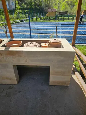 a wooden table with four pots on top of it at Prenociste Vranjska banja in Vranjska Banja