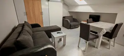a living room with a couch and a table at Studio Dumitrašković in Soko Banja