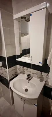 a bathroom with a white sink and a mirror at Studio Dumitrašković in Soko Banja
