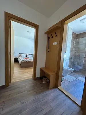 a bathroom with a glass door leading to a bedroom at Apartman Nina in Soko Banja