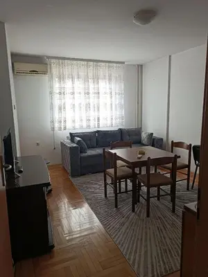a living room with a table and a couch at Nisava rest in Niš