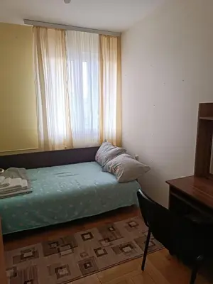 a small bedroom with a bed with a window at Nisava rest in Niš