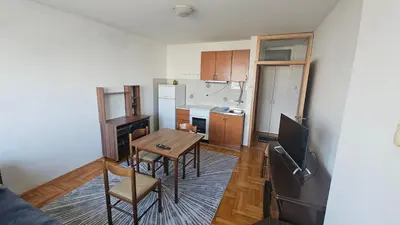 a small kitchen with a table and chairs in it at Nisava rest in Niš