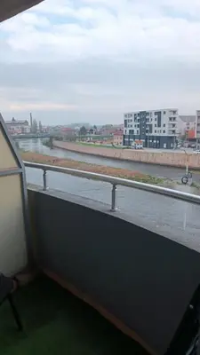 a window with a view of a river and buildings at Nisava rest in Niš