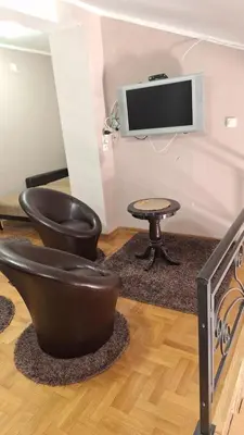 a living room with two chairs and a table at Royal Lux in Soko Banja