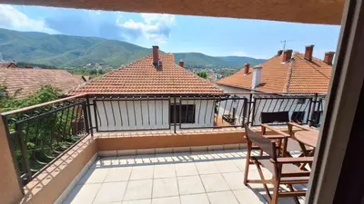 a balcony of a house with mountains in the background at Royal Lux in Soko Banja