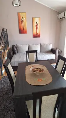 a living room with a table and a couch at Royal Lux in Soko Banja