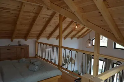 a bedroom with a bed in a room with wooden ceilings at Montana Goc in Goč
