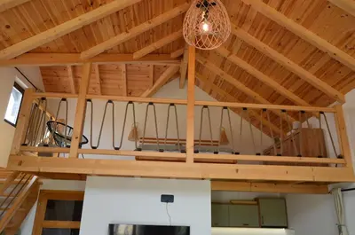 a room with a wooden ceiling with a chandelier at Montana Goc in Goč