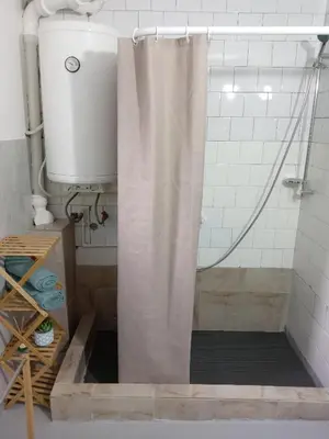 a shower with a shower curtain in a bathroom at Zen apartman in Zaječar