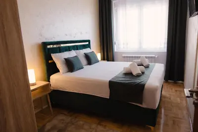 a bedroom with a bed with two towels on it at Lux 010 in Pirot