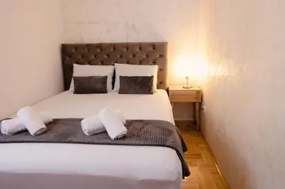 a bedroom with a large white bed with two pillows at Lux 010 in Pirot
