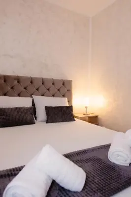 a bedroom with a bed with white towels on it at Lux 010 in Pirot