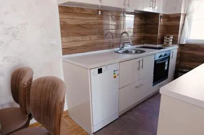 a small kitchen with a sink and a stove at Lux 010 in Pirot