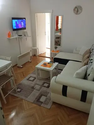 a living room with a couch and a table at Banjski Raj in Vrnjačka Banja