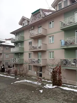 a large apartment building with snow on the ground at Banjski Raj in Vrnjačka Banja