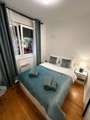 a bedroom with a bed with two towels on it at Apartman Vuk in Vrnjačka Banja