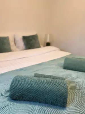 a bed with a pillow on top of it at Apartman Vuk in Vrnjačka Banja