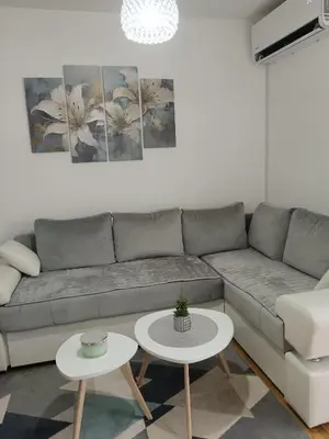 a living room with a couch and two tables at Apartman Sofija in Vrnjačka Banja