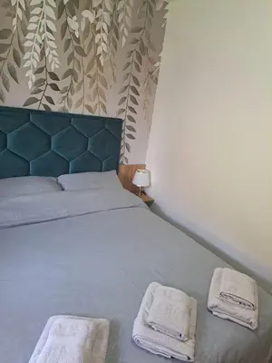 a bedroom with a bed with two towels on it at Apartman Sofija in Vrnjačka Banja