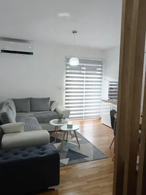 a living room with a couch and a table at Apartman Sofija in Vrnjačka Banja