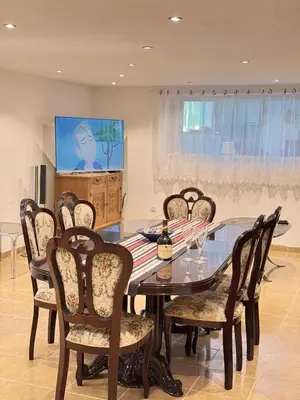 a dining room with a glass table and chairs at Villa Perla in Despotovac