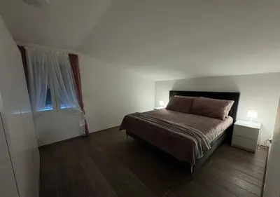 a small bedroom with a bed and a window at Villa Perla in Despotovac