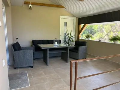 a dining room with a table and two chairs at Sobe Miloš Dimić in Sijarinska Banja