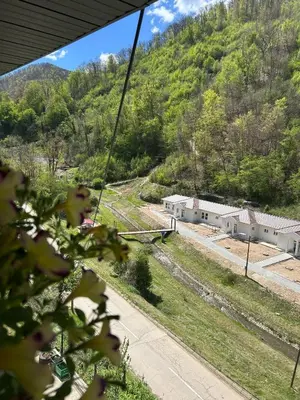 a view of a train yard with a mountain at Sobe Miloš Dimić in Sijarinska Banja