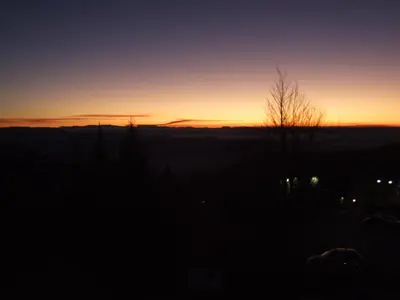 a sunset in the sky with the sun setting at Apartment 204 in Kopaonik