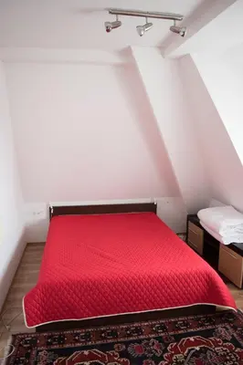 a red bed in a room with a attic at Apartment 204 in Kopaonik