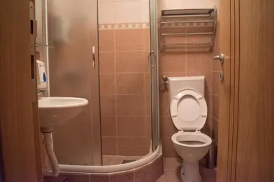 a bathroom with a toilet and a sink at Apartment 204 in Kopaonik