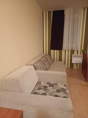 a small living room with a couch and a table at Appartement Kopaonik in Raška