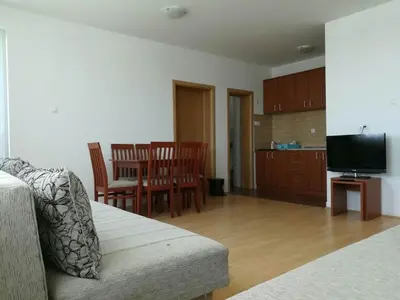 a living room with a couch and a table with chairs at Appartement Kopaonik in Raška